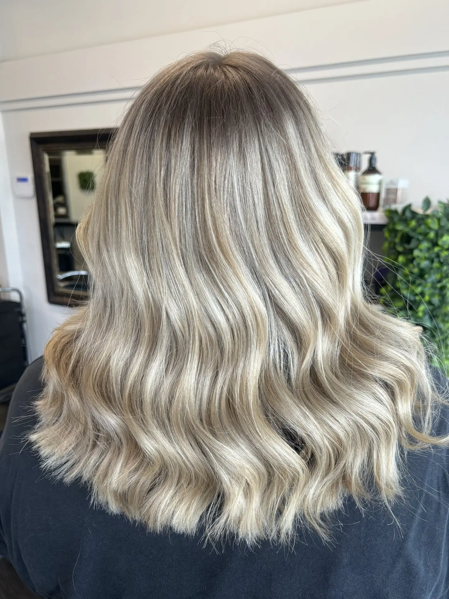 image of a womans blonde hair freshly done in Vogue Hair & Barbers