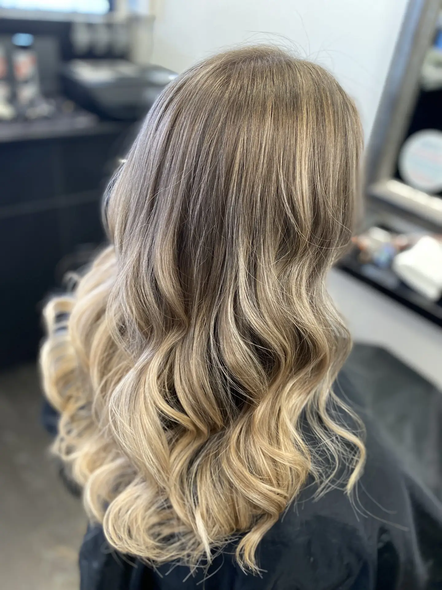 image of a womans blonde hair freshly done in Vogue Hair & Barbers