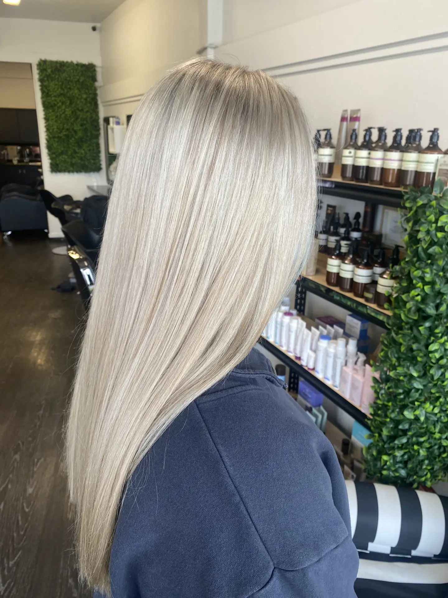 image of a womans blonde hair freshly done in Vogue Hair & Barbers