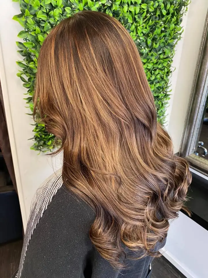 image of a womans brunette hair freshly done in Vogue Hair & Barbers