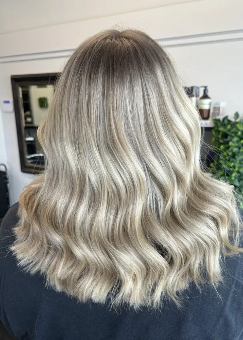 image of a womans blonde hair freshly done in Vogue Hair & Barbers