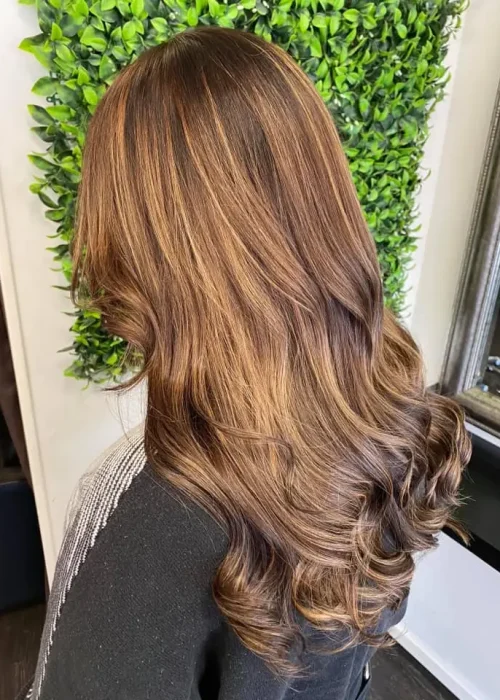 image of a womans brunette hair freshly done in Vogue Hair & Barbers